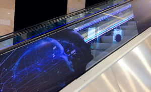 Optically Clear SKINZ securely attached to escalator